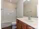 Well-lit bathroom showcasing a vanity with sink, toilet, and bathtub with shower head at 14309 Stonewater Ct, Fort Mill, SC 29707