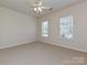 Bedroom with neutral walls, carpet, and two windows providing natural light at 14309 Stonewater Ct, Fort Mill, SC 29707