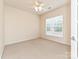 Bright bedroom with neutral carpet, ceiling fan, and large window for natural light at 14309 Stonewater Ct, Fort Mill, SC 29707