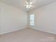 Bedroom with neutral walls, carpeted flooring, and a window providing natural light at 14309 Stonewater Ct, Fort Mill, SC 29707