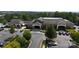 Aerial view of the Sun City Carolina Lakes clubhouse with ample parking and well-maintained grounds at 14309 Stonewater Ct, Fort Mill, SC 29707