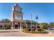 View of the Sun City Carolina Lakes community center featuring a clock tower and manicured landscaping at 14309 Stonewater Ct, Fort Mill, SC 29707