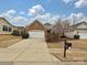 Charming brick home featuring a two-car garage, lovely landscaping, and a well-manicured lawn at 14309 Stonewater Ct, Fort Mill, SC 29707