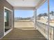 Relaxing back porch area with wooden flooring and a view of the expansive backyard at 15633 Aviary Orchard Way, Charlotte, NC 28278