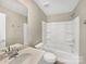 Modern bathroom featuring a bathtub and shower combo, a vanity sink, and sleek fixtures at 15633 Aviary Orchard Way, Charlotte, NC 28278