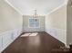 Formal dining room is awash in natural light and boasts dark hardwood flooring and elegant molding details at 15633 Aviary Orchard Way, Charlotte, NC 28278