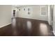 Bright and spacious living room with newly installed dark hardwood floors, and lots of natural lighting at 15633 Aviary Orchard Way, Charlotte, NC 28278