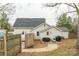 View of the house from the fenced backyard, including a wood deck and patio for outdoor living at 1611 Old Hickory Grove Rd, Mount Holly, NC 28120