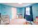 Bedroom with blue walls and a rocking chair by the window at 1611 Old Hickory Grove Rd, Mount Holly, NC 28120