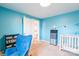 Bedroom with crib, changing table, blue accent walls at 1611 Old Hickory Grove Rd, Mount Holly, NC 28120