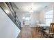 Charming dining area with hardwood floors, a staircase, and an open view into the kitchen at 1611 Old Hickory Grove Rd, Mount Holly, NC 28120