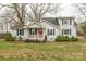 Traditional home featuring black shutters, a cozy porch, and a landscaped front yard at 1611 Old Hickory Grove Rd, Mount Holly, NC 28120