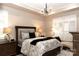 Serene bedroom with a comfortable bed, chandelier lighting, and plantation shutters at 16116 Lakeside Loop Ln, Cornelius, NC 28031