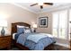 Comfortable bedroom with a wooden bed frame, plantation shutters, and stylish decor at 16116 Lakeside Loop Ln, Cornelius, NC 28031
