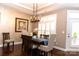 Elegant dining area featuring hardwood floors, plantation shutters, and modern chandelier at 16116 Lakeside Loop Ln, Cornelius, NC 28031