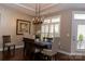 Elegant dining area with a modern chandelier, hardwood floors, and a serene ambiance at 16116 Lakeside Loop Ln, Cornelius, NC 28031