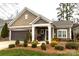 Charming single-story home with beautiful landscaping and a welcoming front porch at 16116 Lakeside Loop Ln, Cornelius, NC 28031