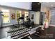 Fully equipped gym with mirrored wall, various exercise machines, weights, and natural light at 16116 Lakeside Loop Ln, Cornelius, NC 28031