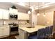 Modern kitchen with granite countertops, stainless steel appliances, and a breakfast bar at 16116 Lakeside Loop Ln, Cornelius, NC 28031