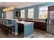 Stylish kitchen with stainless steel appliances, ample counter space, and a breakfast bar at 16116 Lakeside Loop Ln, Cornelius, NC 28031