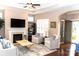 Bright living room featuring a fireplace, hardwood floors, and elegant furnishings at 16116 Lakeside Loop Ln, Cornelius, NC 28031