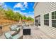 Wide view of the wooden deck with outdoor seating, a fire pit, and access to a screened-in porch at 1660 Sassafras Ct, Fort Mill, SC 29715