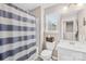 Bright bathroom featuring a shower with blue striped curtain and a window for natural light at 1660 Sassafras Ct, Fort Mill, SC 29715