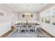 Traditional dining room featuring wood floors, wainscoting, an elegant chandelier, and an area rug at 1660 Sassafras Ct, Fort Mill, SC 29715