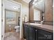 Bathroom features a vanity with a sink, a mirror, and a toilet at 170 Louise Dr, Mooresville, NC 28115