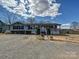 Charming single-story home with light blue siding, front porch, and gravel driveway at 170 Louise Dr, Mooresville, NC 28115