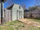 Backyard shed with weathered wooden details, a ramp, and secure door for storage and workshop needs at 170 Louise Dr, Mooresville, NC 28115