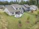 Aerial view of a well-maintained backyard with patio, landscaping, and lush green lawn at 17015 River Race Dr, Huntersville, NC 28078