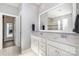 Bathroom with double vanity, a large mirror, and a tiled shower, offering a spa-like experience at 17015 River Race Dr, Huntersville, NC 28078