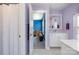 Charming bathroom with white cabinets and a doorway view into a blue home office at 17015 River Race Dr, Huntersville, NC 28078