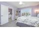 Light-filled bedroom with ensuite bathroom and comfortable bed with stylish patterned bedding at 17015 River Race Dr, Huntersville, NC 28078