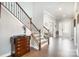 Open foyer featuring hardwood floors, staircase with iron railings, and views of the front entrance at 17015 River Race Dr, Huntersville, NC 28078