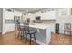 Bright kitchen featuring white cabinets, stainless appliances, and hardwood floors at 17015 River Race Dr, Huntersville, NC 28078