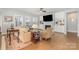 Bright living room boasting built-in shelving, a fireplace, and hardwood floors at 17015 River Race Dr, Huntersville, NC 28078