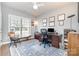 Home office featuring a large desk, natural light, and a ceiling fan, offering a comfortable workspace at 17015 River Race Dr, Huntersville, NC 28078