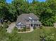 Aerial view of beautiful two-story home with lush landscaping and charming front porch at 1708 Meadow Crest Ct, Matthews, NC 28104