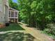 Exterior of the screened-in porch, backyard, and wooded area behind the home at 1708 Meadow Crest Ct, Matthews, NC 28104