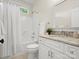 Bright bathroom features a shower-tub combo, granite countertop vanity, and a mirror at 1708 Meadow Crest Ct, Matthews, NC 28104