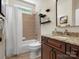The cozy bathroom features great tile, a tub and shower, and a lovely vanity area at 1708 Meadow Crest Ct, Matthews, NC 28104