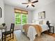 Comfortable bedroom featuring a ceiling fan, natural lighting and calm decor at 1708 Meadow Crest Ct, Matthews, NC 28104