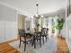 Bright dining room features modern lighting, hardwood floors, and many windows allowing for natural light at 1708 Meadow Crest Ct, Matthews, NC 28104