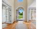 Grand home foyer with hardwood floors and a view of the outdoors through the front door at 1708 Meadow Crest Ct, Matthews, NC 28104