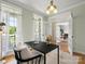 Bright office showcasing natural light, a sleek desk, and views of the outdoors at 1708 Meadow Crest Ct, Matthews, NC 28104