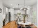 Spacious kitchen features white cabinets, granite countertops, hardwood floors, and stainless steel appliances at 1708 Meadow Crest Ct, Matthews, NC 28104