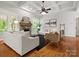 Bright living room with hardwood floors, natural lighting and a stone fireplace at 1708 Meadow Crest Ct, Matthews, NC 28104