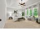 Brightly lit main bedroom with trey ceilings, a ceiling fan and large windows at 1708 Meadow Crest Ct, Matthews, NC 28104